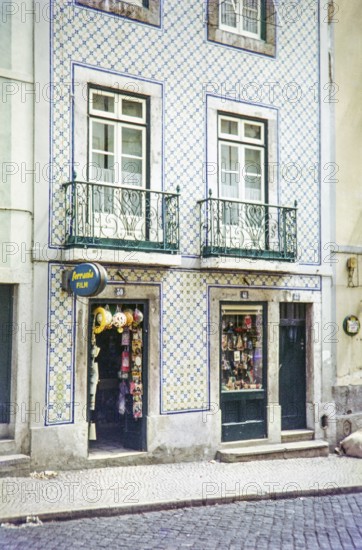 Typical Portuguese building facade with blue and white azulejo tiles shop selling film and souvenirs, Portugal, Europe 1968