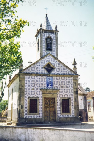 This building is the Capela de São João de Ovar (Chapel of St. John of Ovar), located in Ovar, Portugal. It is a traditional Portuguese chapel famous for its beautiful exterior facade covered in blue and white azulejo tiles