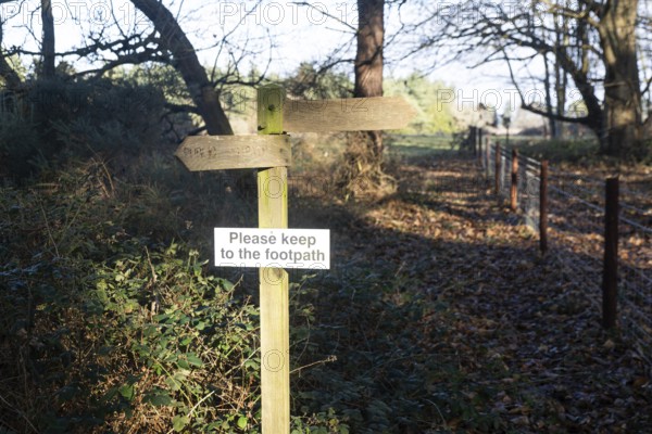 Please Keep To The Footpath wooden signpost in countryside, Sutton, Suffolk, England, UK