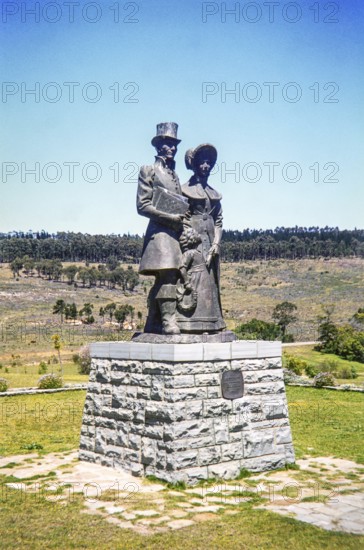 Bronze statue of a Victorian-era settler family (a man, woman, and child) at the 1820 Settlers National Monument in Grahamstown (now Makhanda), South Africa