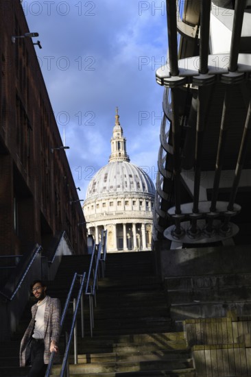 London, UK. January 31st 2025. A stylish man poses for a photo on the steps of the Thames embankment with the dome of St Pauls in the background, central London, UK