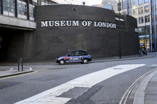 London, UK. January 31st 2025. A classic London black cab passing the Museum of London, covering the history of the city from prehistoric to modern times, with a particular focus on social history