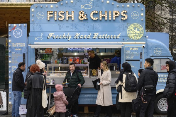 A blue retro Citroen food truck selling traditional British fish and chips on the south bank of the Thames, London, UK