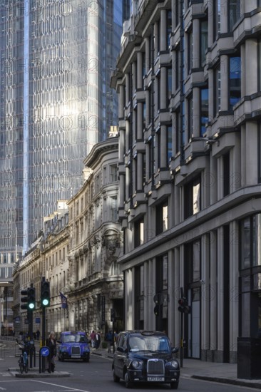 London, UK. January 29th 2025. Traditional London cabs drive along historic Threadneedle Street in the City of London, the finance and corporate heart of the United Kingdom