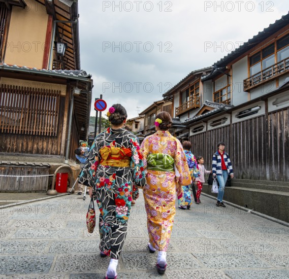 Two Japanese woman wearing kimonos in an alley with traditional Japanese houses, Higashiyama, Kyoto, Japan