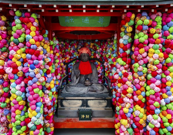 Colorful kukurizaru balls and Buddha statue, Yasaka Koshin-do Temple, Higashiyama, Kyoto, Japan