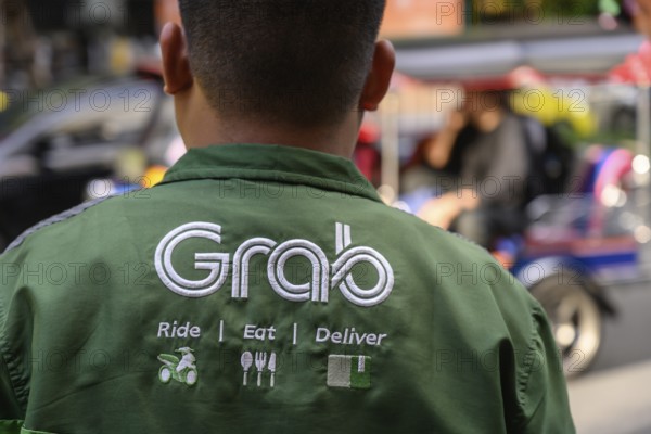Bangkok, Thailand. March 25th 2025. A Grab food delivery service logo displayed on the shirt of a Grab delivery rider in Bangkok, Thailand, Asia