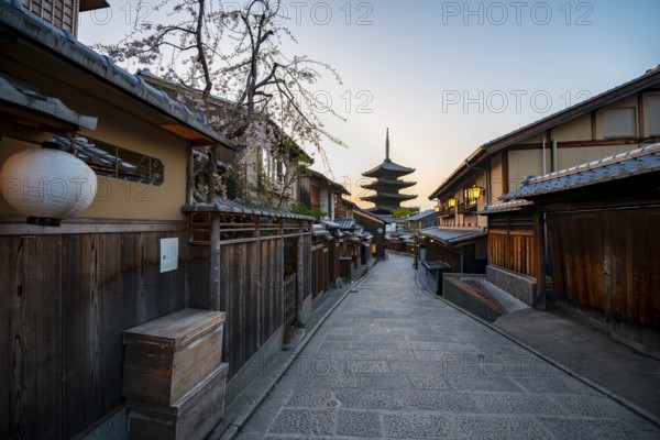 Yasaka dori historic street in the old town with traditional Japanese houses, five-story Yasaka Pagoda of the Buddhist Hokanji Temple at the back, evening mood, sunset, Higashiyama, Kyoto, Japan