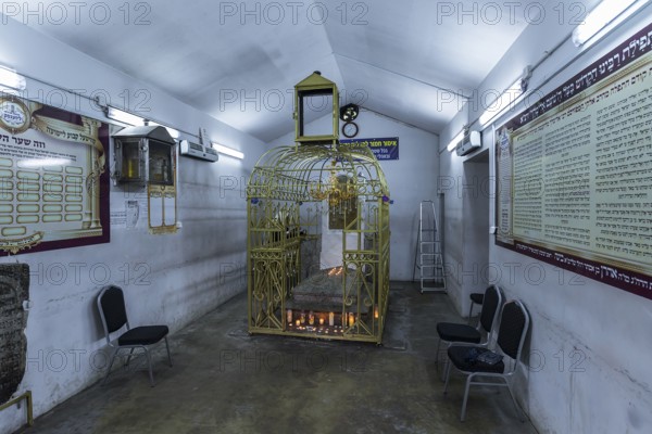 Tomb of Hasidic Rabbi Elimelech in a gilded grid at the Lezajsk Jewish Cemetery, Poland
