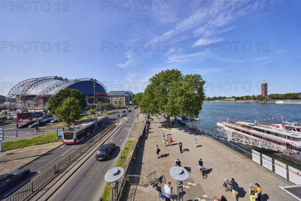Rhine river, large tent Musical Dome, exhibition tower, general architecture, footpath, waterfront, street, public bus, cars, wharf, gangway, excursion boats, pedestrians as accessories, lawn, trees, elevated perspective, blue sky, cirrus clouds, federal road B51, Konrad-Adenauer-Ufer, Cologne, district-free city, North Rhine-Westphalia, Germany