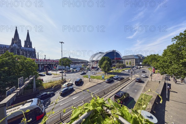 Large tent Musical Dome, double tower, cathedral, general architecture, lantern, main station, roads, footpath, lanes, central island, pedestrian crossing, vehicles, lawn, trees, elevated perspective, side light, blue sky, cirrus clouds, federal road B51, Konrad-Adenauer-Ufer intersection with Trankgasse, Cologne, district-free city, North Rhine-Westphalia, Germany