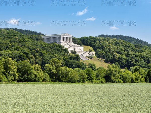 View across a green cornfield to the Walhalla Memorial on the Bräuberg, Donaustauf, Upper Palatinate, Bavaria, Germany