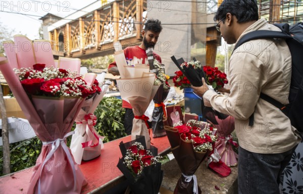 Customers browse red roses and other flowers at a roadside flower shop on Valentine's Day, in Guwahati, India on 14 February 2026