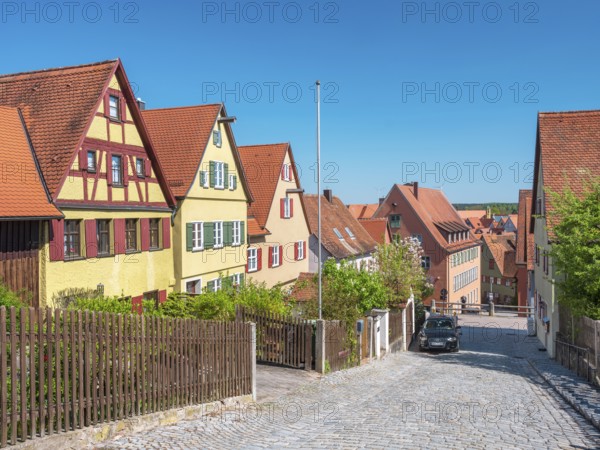 Street with typical town houses, wooden fences and cobblestones, Dinkelsbühl, Ansbach district, Middle Franconia, Bavaria, Germany