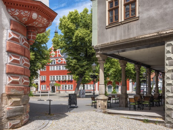 Houses and arcades on the market square in the historic old town, in the back the town hall, Arnstadt, Thuringia, Germany