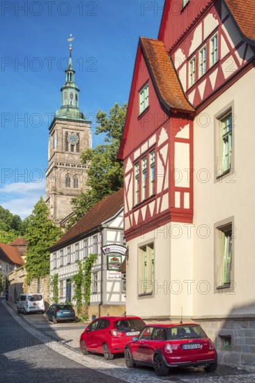 Street with half-timbered houses and cobblestones at the Gothic St. Mary's Church, Königsberg in Bavaria, Lower Franconia, Bavaria, Germany