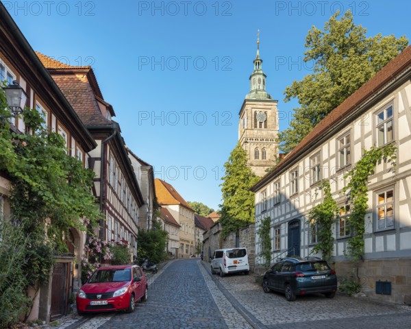 Street with half-timbered houses and cobblestones at the Gothic St. Mary's Church, Königsberg in Bavaria, Lower Franconia, Bavaria, Germany
