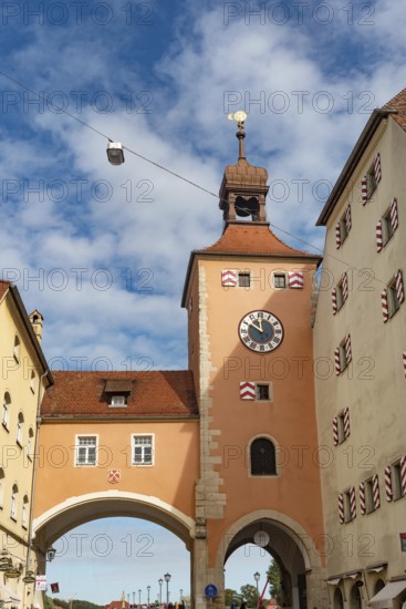 Regensburg, Germany. October 7th 2024 Regensburg Clock Tower at the entrance of the Stone Bridge, iconic landmarks of medieval Bavarian German city of Regensburg on the River Danube, Germany