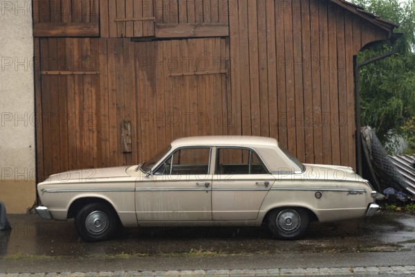 Rhine Falls, Switzerland. 26th September 2024 Plymouth Valiant 200 four-door sedan car, an automobile manufactured by the Chrysler Company. A popular compact car parked outside a garage in Switzerland