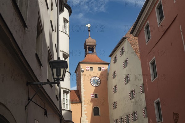 Regensburg, Germany. October 7th 2024 Regensburg Clock Tower at the entrance of the Stone Bridge, iconic landmarks of medieval Bavarian German city of Regensburg on the River Danube, Germany