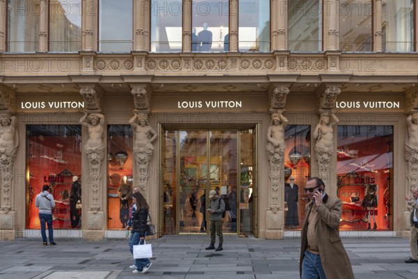 Vienna, Austria. October 15th 2024 Shopper in a busy fashionable shopping street in the centre of Vienna, a popular district with high end brand names selling luxury gifts