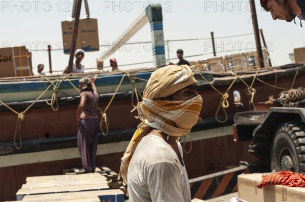 Dubai, United Arab Emirates. June 29th 2019 Foreign workers unloading cargo from Dhow boats Dubai Creek Harbour, a busy commercial district of Deira, Dubai, UAE