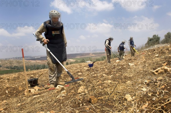 Tyre, Lebanon. July 15th 2010 A team from The Mines Advisory Group (MAG) clearing unexploded cluster munitions in the farmland of southern Lebanon, a result of the conflict with Israel