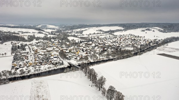 Snowy village with river and hills in the background, quiet winter atmosphere, Lauchröden in Thuringia