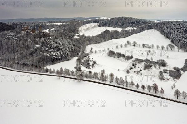 Snowy hill and field landscape with visible ruin on the edge, The Brandenburg in the Werra Valley near Eisenach