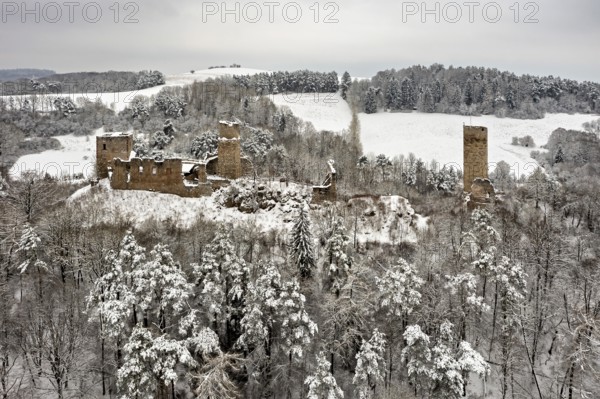 Old castle ruins in a snowy, wooded winter landscape, The Brandenburg in the Werra Valley near Eisenach