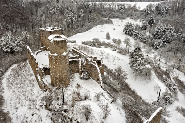 Snowy castle ruins in a wintry landscape with forest and hills, The Brandenburg in the Werra Valley near Eisenach