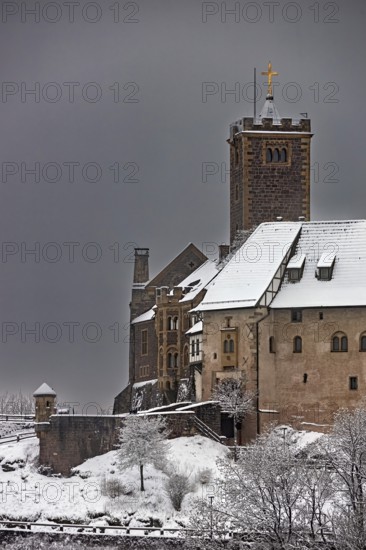 Detailed view of a part of a castle in winter with a snow-covered roof under a grey sky, The Wartburg near Eisenach in Thuringia