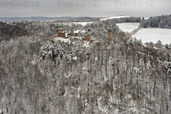 Wide view of a ruin in a wintry forest with snow-covered hills, The Brandenburg in the Werra Valley near Eisenach