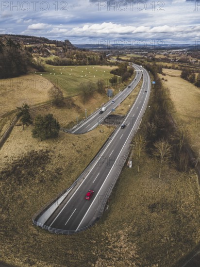The A81 motorway passes through the 782 meter long Hohentwiel Tunnel just in front of the Swiss border, the Hohenkrähen Hegau volcano on the left, aerial view, Konstanz district, Baden-Württemberg, Germany