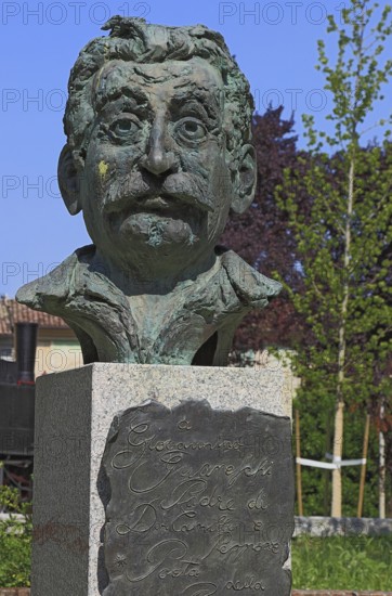 Brescello, statue of the writer Giovannino Guareschi in Parco Giovannino Guareschi, author of the films by Don Camillo and Peppone, Emilia-Romagna, Italy