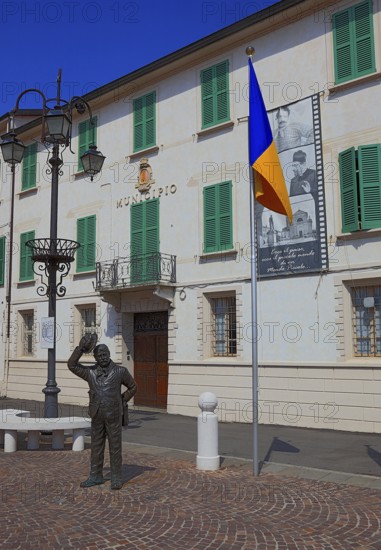 Italy, village of Brescello, the town hall, known from Don Camillo and Peppone, with a bronze figure of Peppone, Mayor Giuseppe Bottazzi portrayed by actor Gino Cervi