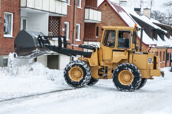 Loader clearing snow on streets in Ystad, Skåne County, Sweden, Scandinavia
