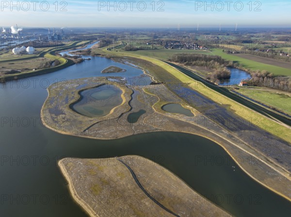 Haltern-Marl, North Rhine-Westphalia, Germany - Lippe, flood protection in the Haltern-Lippramsdorf-Marl area (HaLiMa) . Flood protection on the River Lippe by relocating the dyke and thus extending the floodplain. On the right, the completed floodplain north, the north dyke. Work is still underway on the south dyke. Marl Chemical Park in the back