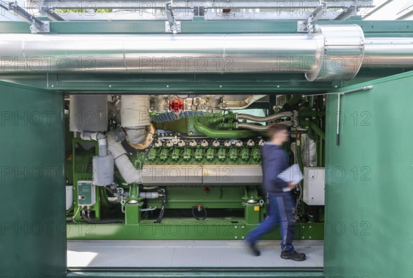 Dinslaken, North Rhine-Westphalia, Germany - Combined heat and power plants (CHP) generate electricity from wastewater digester gases, which is used by the Emscher-Mündung sewage treatment plant for its own power supply. The old CHP unit at the Emscher-Mündung sewage treatment plant in Dinslaken is getting on in years and needs to be replaced. Temporary rental CHP units (pictured here) relieve the stationary CHP units so that they can then be renewed or replaced