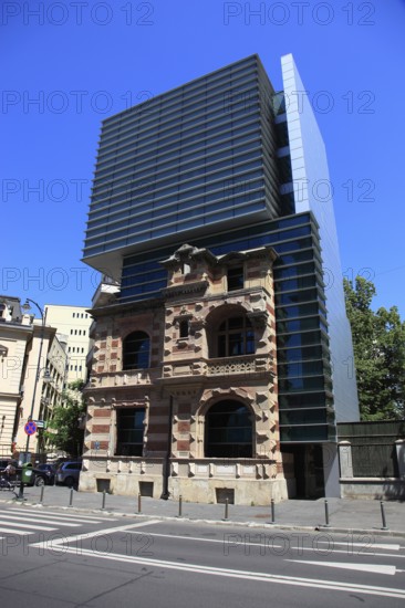 Romania, capital Bucharest, Bucuresti, House of the Union of Romanian Architects, The building is known for its distinctive architectural combination of old and new, with a modern glass tower rising from the ruins of a historic house, the original Paucescu House building was built around 1880 in the French Renaissance style and was severely damaged during the Romanian Revolution of 1989