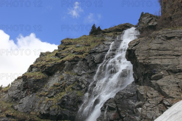 Torrent on the Transfogarasan Highway, Transfagarasan, connects the Arges Valley in Great Wallachia with the Olt Valley in Transylvania, crossing the Fagaras Mountains in the Transylvania Alps, to melt snow in May, Romania