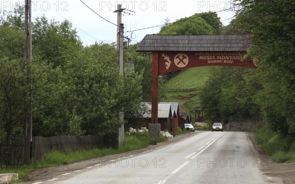 Rosia Montana mining village, Goldbach, historically important community known for its ancient Roman gold mines and the long-standing conflict over a planned open-cast mining project, road sign, municipality in Alba County in Transylvania, Romania
