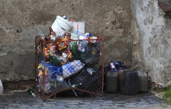 Full garbage container and canister on a corner of a house, garbage, trash, Transylvania, Romania