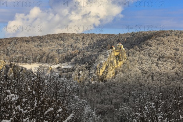 A castle perched on a snow-covered rock surrounded by a thick snowy forest under a blue sky, Bronnen Castle, Upper Danube nature park Park, Tuttlingen District, Baden-Württemberg, Germany
