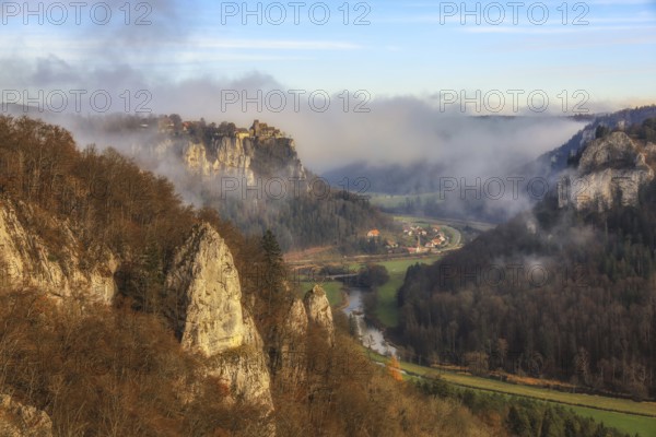 Foggy rock formations and autumn forest in the valley, the Danube snakes through, castle on a rock, Werenwag Castle, Langenbrunn, Beuron, Upper Danube nature park Park, Sigmaringen district, Baden-Württemberg, Germany