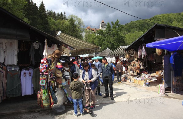 Souvenir sale at Bran Castle, market stalls in front of the entrance, tourists, Törzburg, in Transylvania, Romania. It is famous as Dracula's Castle and one of the country's main attractions