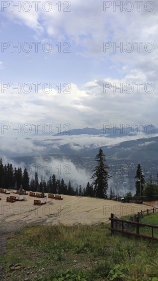Panoramic view from a viewpoint on Mount Gubalowka with clouds, mountains and a town in the valley, Zakopane, hiking in the High Tatras National Park, Carpathian Mountains, Poland
