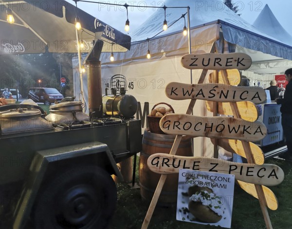 Street vendor with goulash cannon with traditional Polish food at night, illuminated with warm light, Zakopane, hiking in the High Tatras National Park, Carpathian Mountains, Poland
