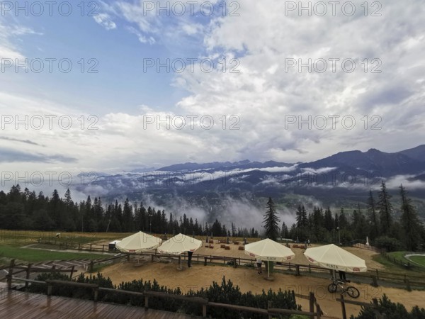 Mountain panorama with clouds, conifers and leisure area, huts and wide sky, Gubalowka, Zakopane, hiking in the High Tatras National Park, Carpathian Mountains, Poland