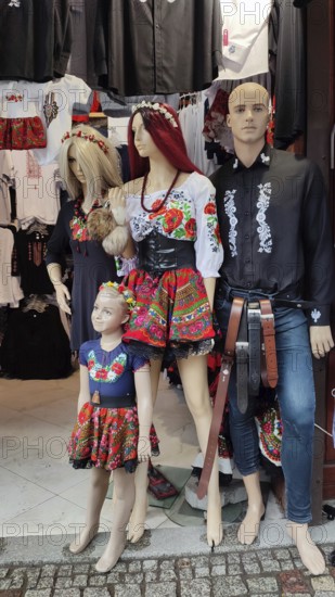 Three dolls in traditional, folkloric clothing with floral patterns in a shop window, Zakopane, hiking in the High Tatras National Park, Carpathian Mountains, Poland